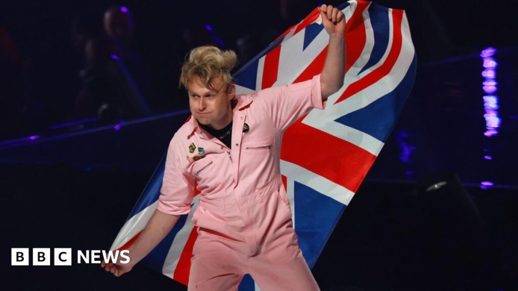 Look Mum No Computer waves a British flag as he walks onto the stage at the 2026 Eurovision Song Contest