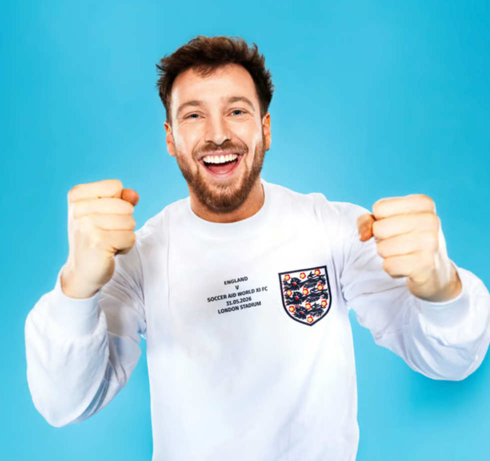 Soccer aid line up person making a fist in a celebratory pose against a blue background