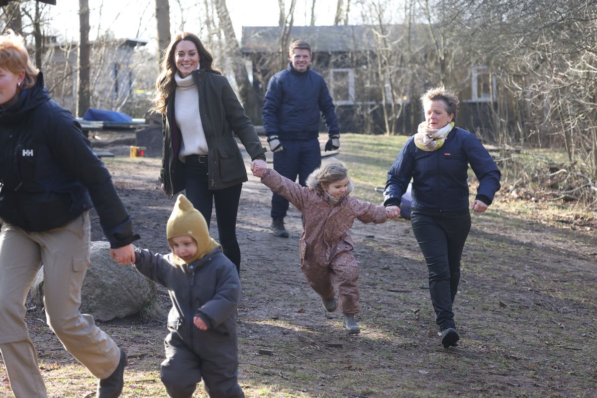 Kate joined in with the children as they ran around the forest 