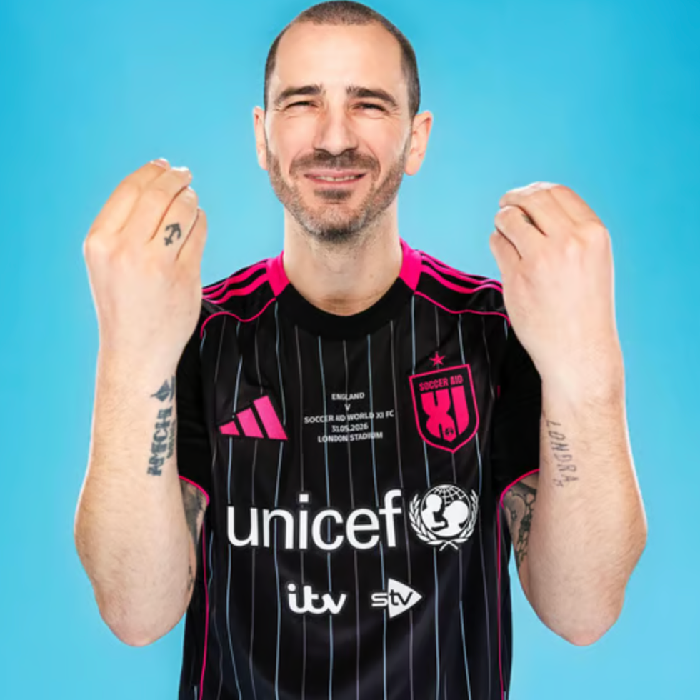 Soccer aid line up individual showing a gesture with hands while wearing a sports jersey