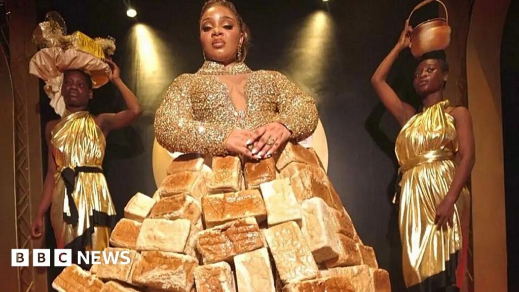 Reality TV star Queen Mercy Atang  is seen with her dress made from loaves of bread