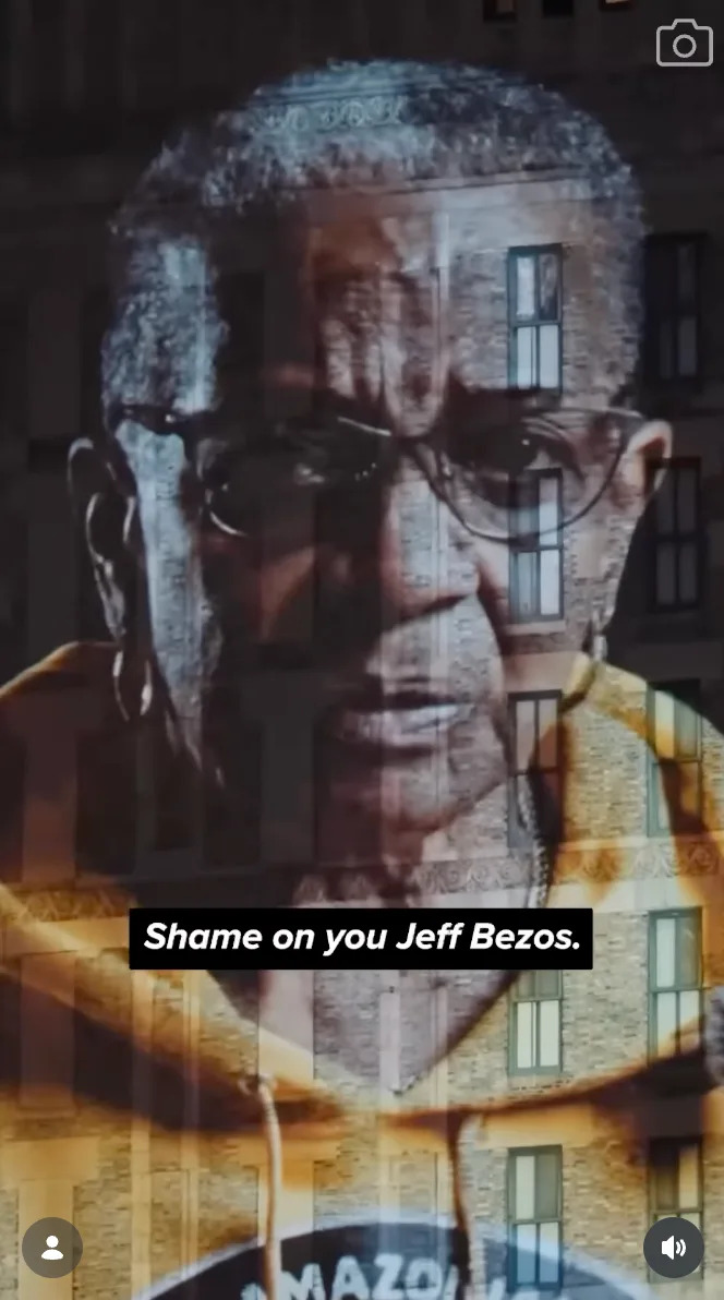 An older person wears glasses and a hoodie in an image with the overlaid text "Shame on you Jeff Bezos."