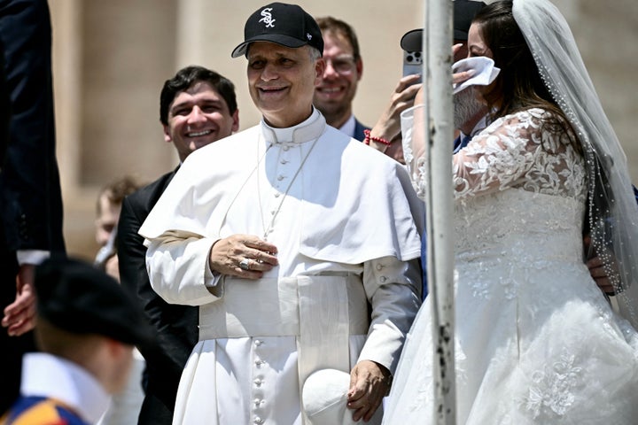 Pope Leo XIV (C) — who hails from Chicago, Illinois — wears a Chicago White Sox baseball team cap as he meets newly wedded couples during the weekly general audience in St Peter's Square at the Vatican on June 11, 2025. 