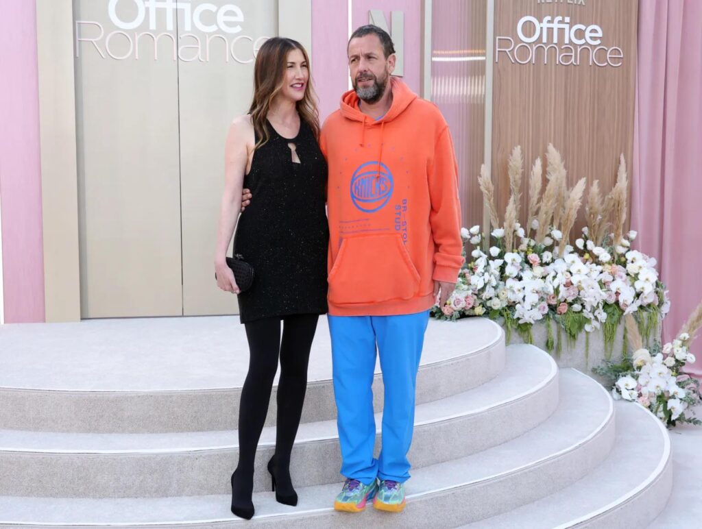 Adam Sandler was at the Office Romance premiere to support his wife, Jackie, who is part of the film's cast. Couldn’t be bothered to change out of his sweats.