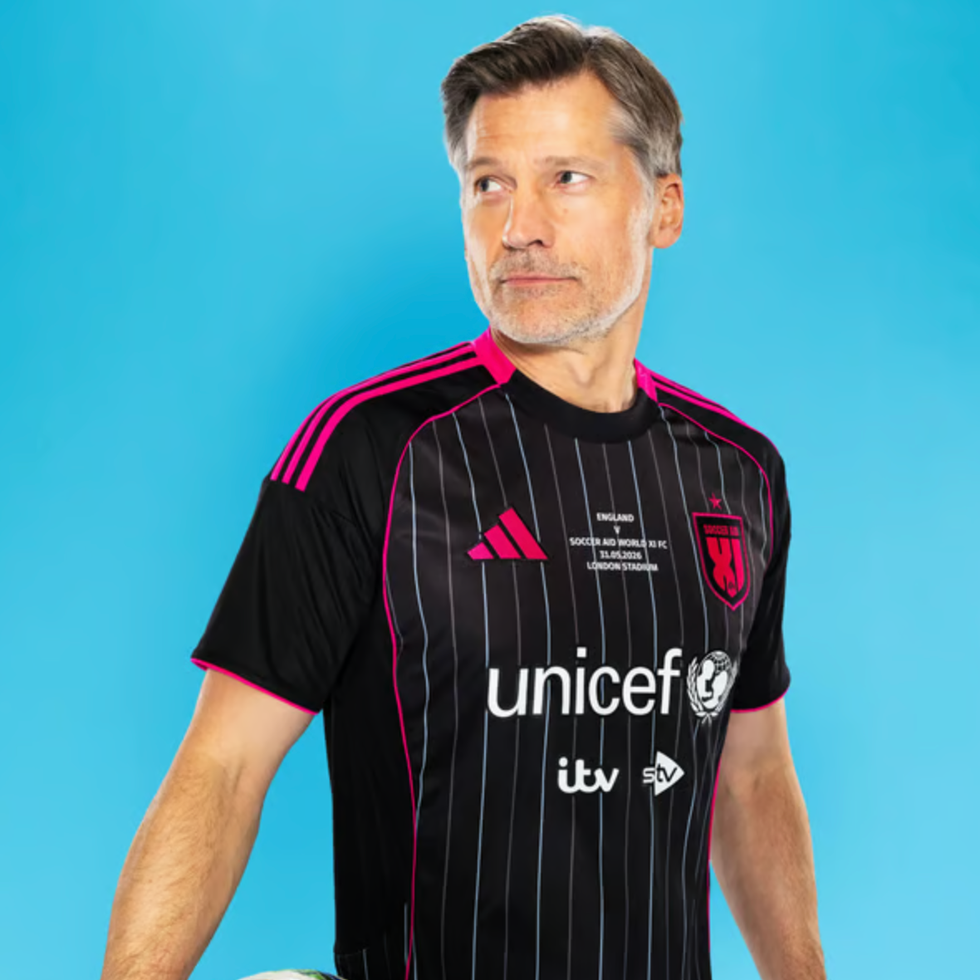 Soccer aid line up a person wearing a black soccer jersey with pink accents and logos