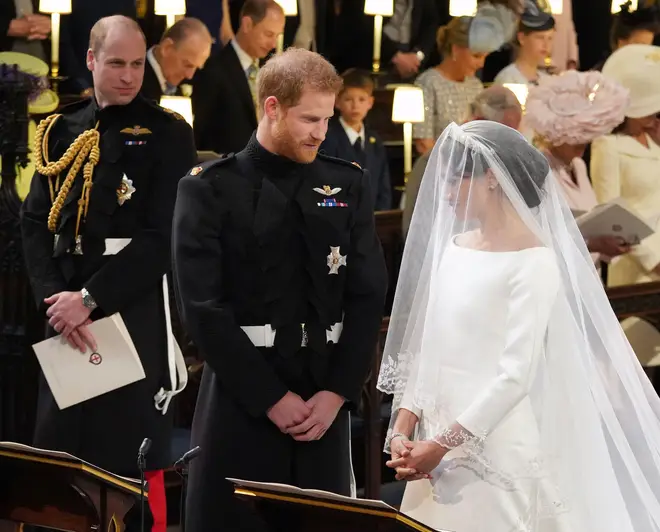 File photo dated 19/05/2018 of Prince William (left) watching Prince Harry and Meghan Markle during their wedding at St George's Chapel, Windsor Castle.