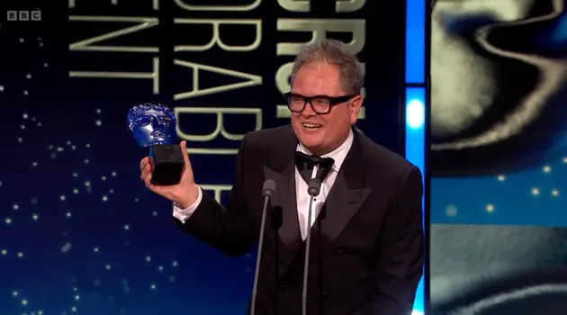 Alan Carr on stage at the 2026 TV Baftas