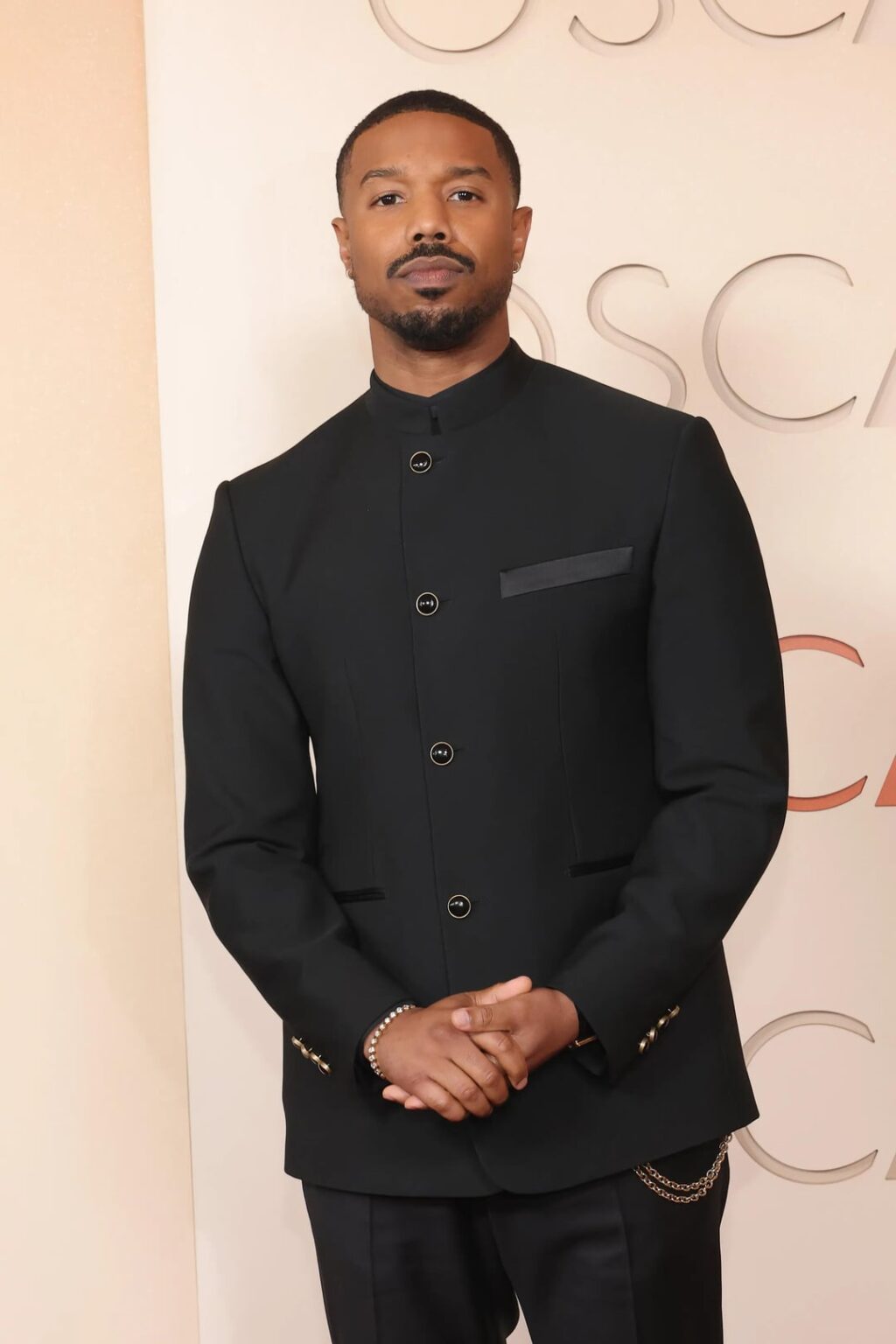Michael B Jordan's 2026 LV Oscars suit is the best version of previous looks. Note the Nehru jacket and mandarin collar. Better version of the Dolce & Gabbana he wore at London Sinners premiere + Better fit than at Critics Choice, also LV by Pharrell