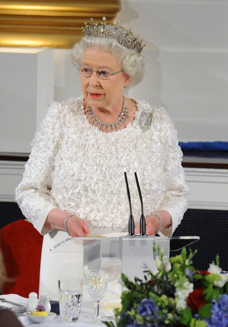 Queen Elizabeth II wearing a gown covered in shammrock for a state dinner at Dublin Castle on May 18, 2011