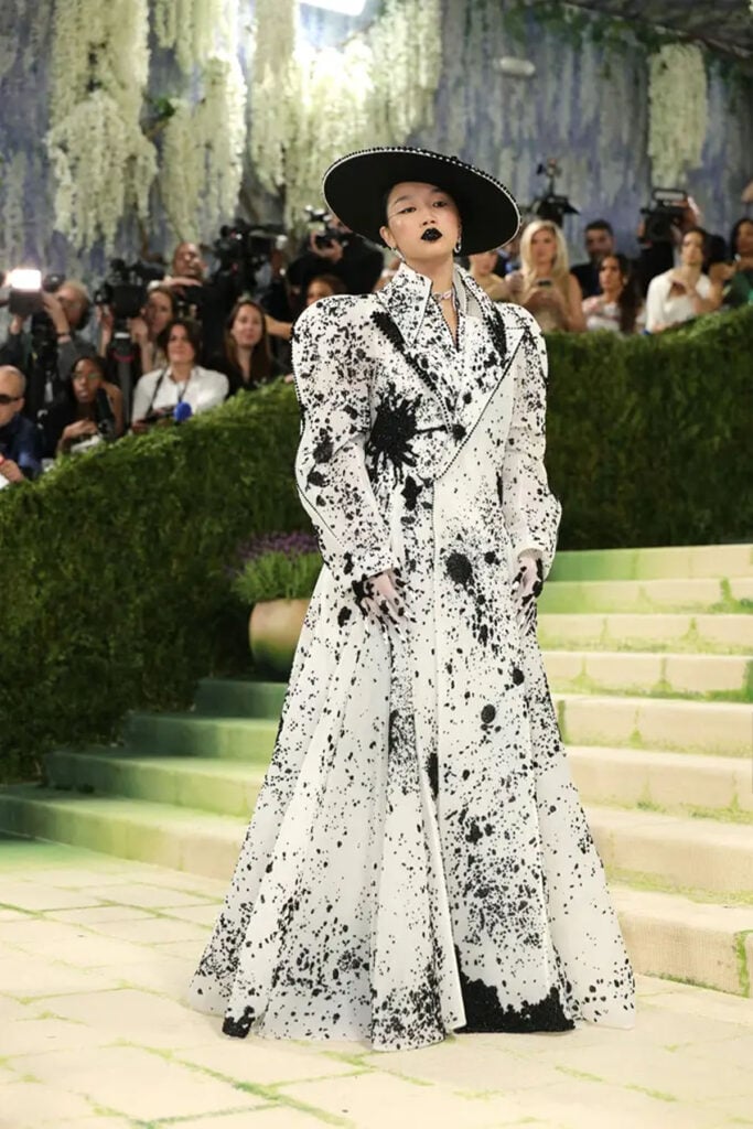 Audrey Nuna in Robert Wun Couture white coat dress with paint effect at the 2026 Met Gala in New York
