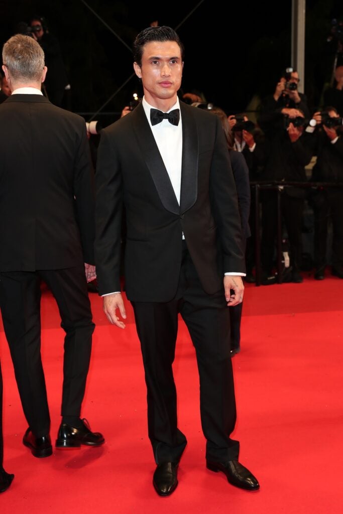 Charles Melton wearing a custom Louis Vuitton tuxedo at the Her Private Hell Cannes premiere.
