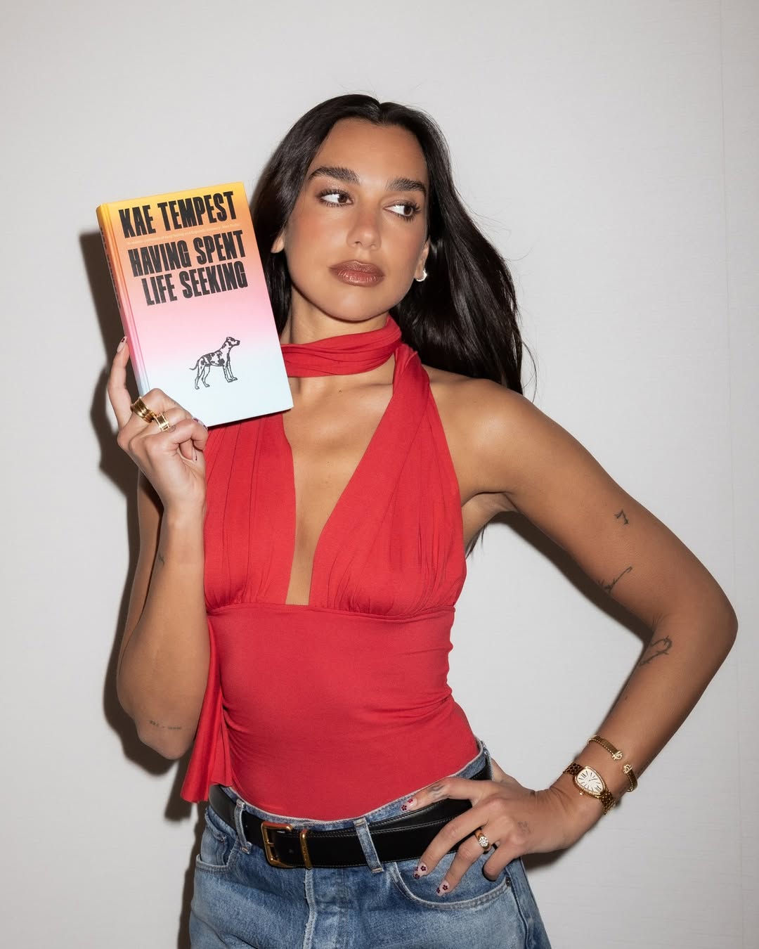 Dua Lipa hops on the strawberry red trend and pairs it with distressed denim, a key Spring 2026 crazy