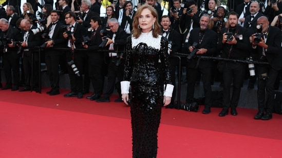French actor Isabelle Huppert embraced timeless Parisian chic in a sparkling black sequinned gown featuring crisp white collar and cuff details.(AFP)