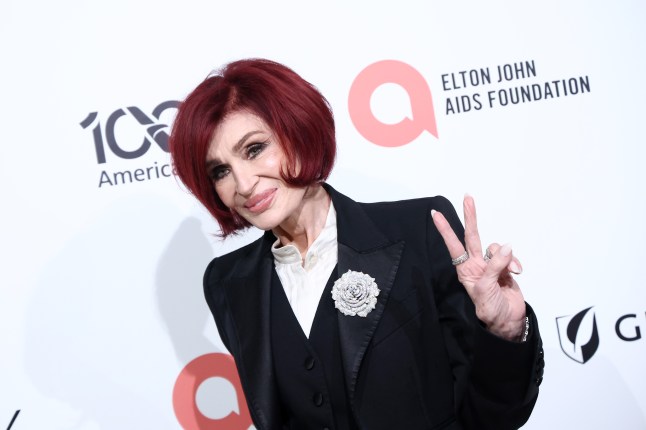 Sharon Osbourne makes a peqace sign at the Elton John AIDS Foundation's 34th Annual Academy Awards Viewing Party
