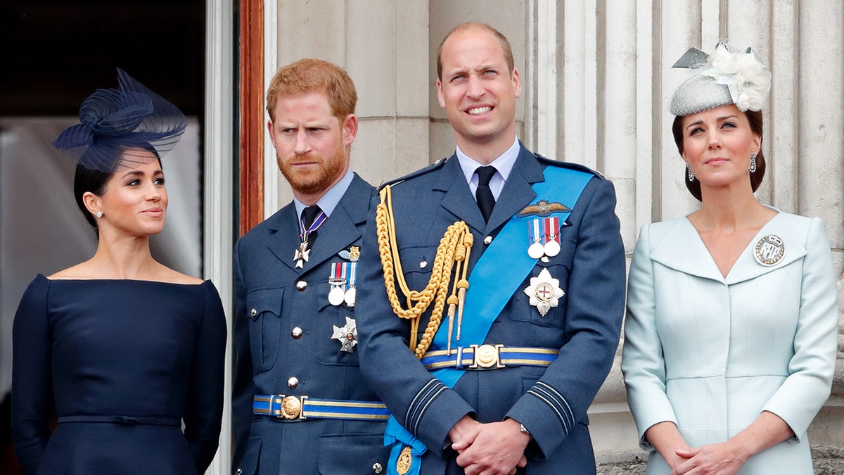 Meghan Duchess of Sussex Prince Harry Duke of Sussex Prince William Duke of Cambridge and Catherine Duchess of Cambridge watching flypast from Buckingham Palace balcony