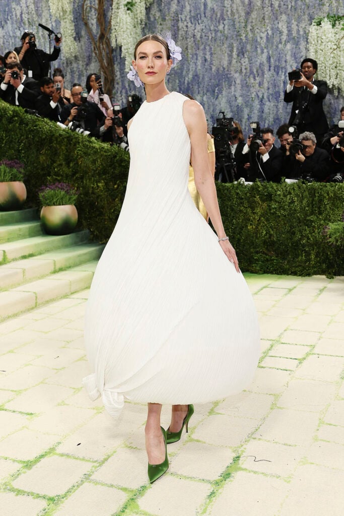 Karlie Kloss wearing Dior Spring 2026 Haute Couture with orchid headpiece and green shoes at the Met Gala