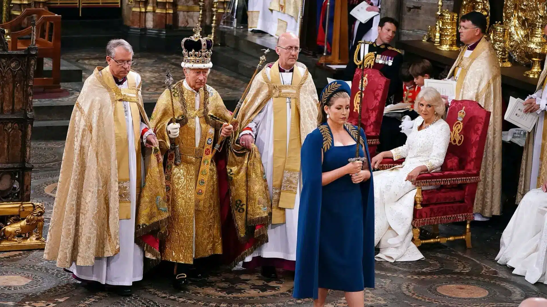 King Charles III during the coronation ceremony at Westminster Abbey surrounded by clergy and royal guests