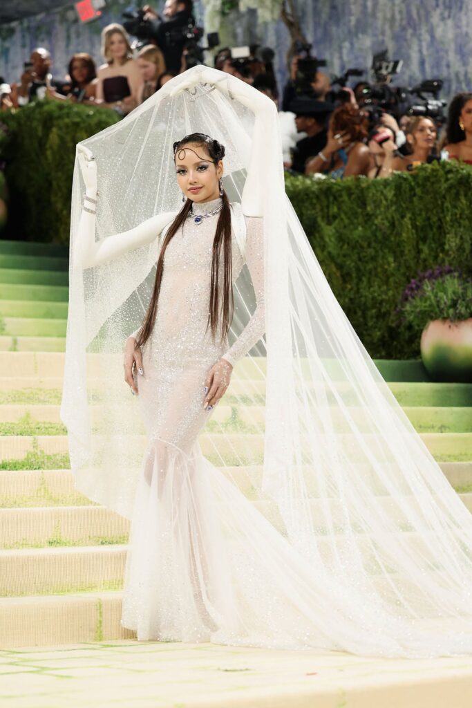 Lisa in custom Robert Wun Couture gown with sculptural arm motifs and veil at the 2026 Met Gala in New York