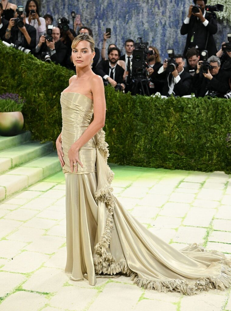 Margot Robbie wearing a gold Chanel lamé gown at the 2026 Met Gala red carpet