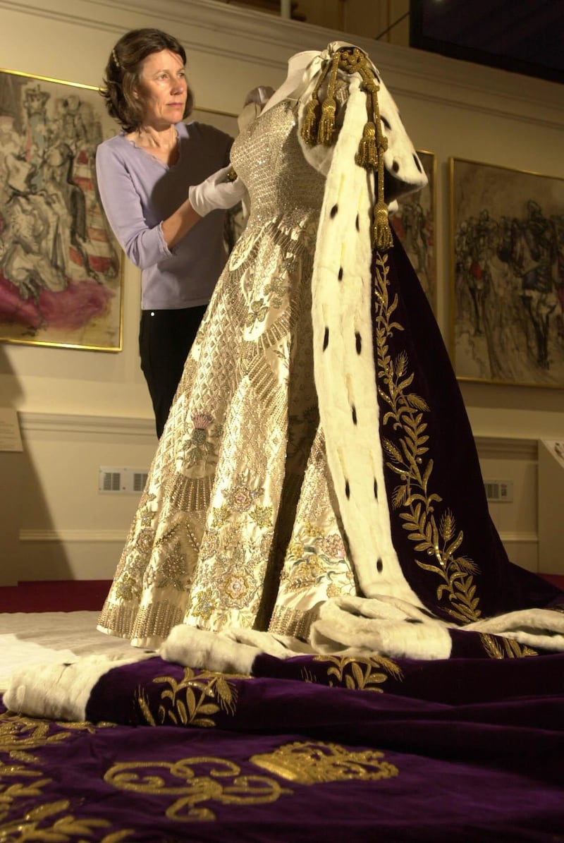 The late queen’s coronation gown on display in the Ball Supper Room at London’s Buckingham Palace