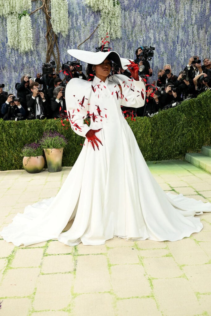 Naomi Osaka in Robert Wun Couture white coat with headpiece at the 2026 Met Gala