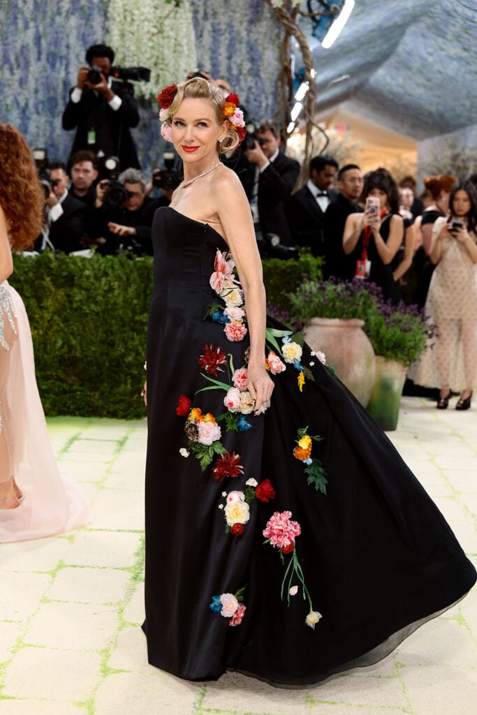 Naomi Watts wearing black satin Dior dress with embroidered flowers at the Met Gala
