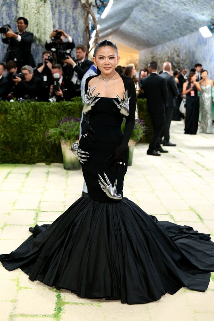 Nichapat Suphap in custom Robert Wun Couture gown with moving metal hands at the 2026 Met Gala