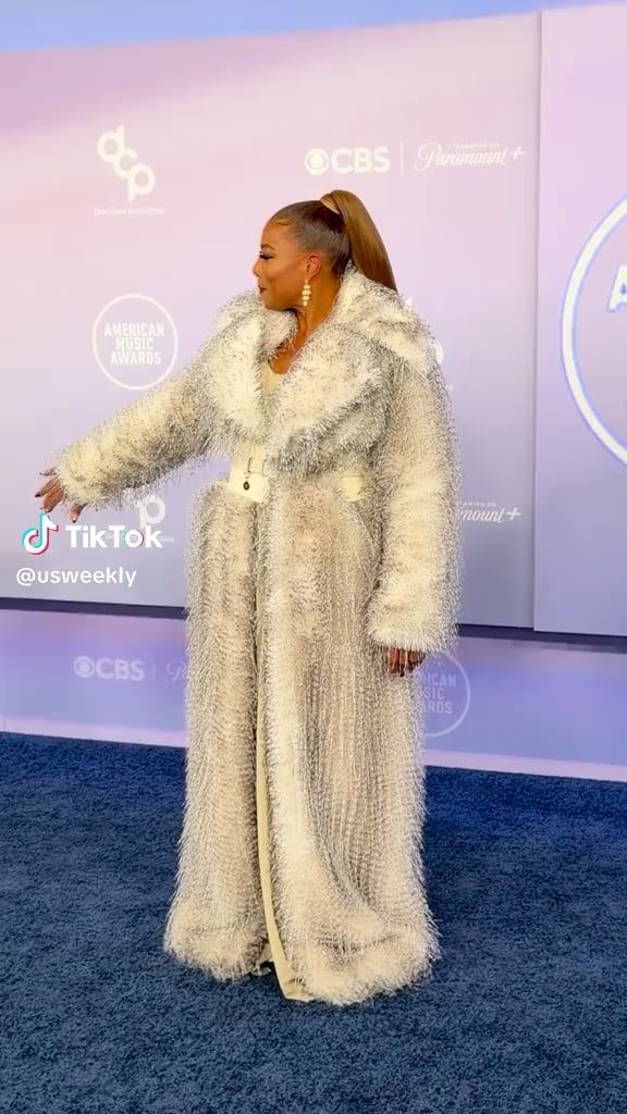 Queen Latifah made a rare red carpet appearance with her family including her partner, Eboni Nichols, and their son, Rebel at the American Music Awards red carpet (May 25, 2026)