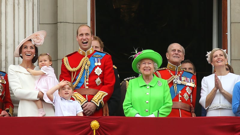 Queen Elizabeth II with the royal family during the Trooping of the Colour in 2016 wearing a bright green coat and hat