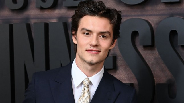 Louis Partridge smiling at an event in 2025.