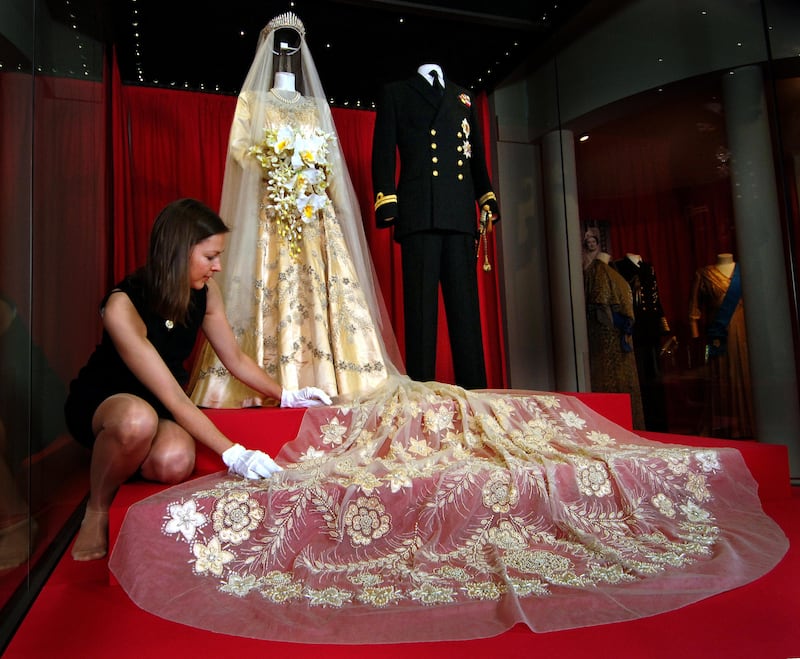 The late queen’s Norman Hartnell wedding dress and 13 foot train on display