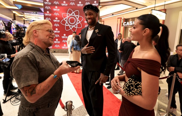 Former National Basketball Association professional athlete Festus Ezeli, middle, and date, are interviewed on the red carpet at the grand opening of Graton Resort and Casino's rooftop restaurant, AYA, Thursday, May 7, 2026, near Rohnert Park. (Kent Porter / The Press Democrat)