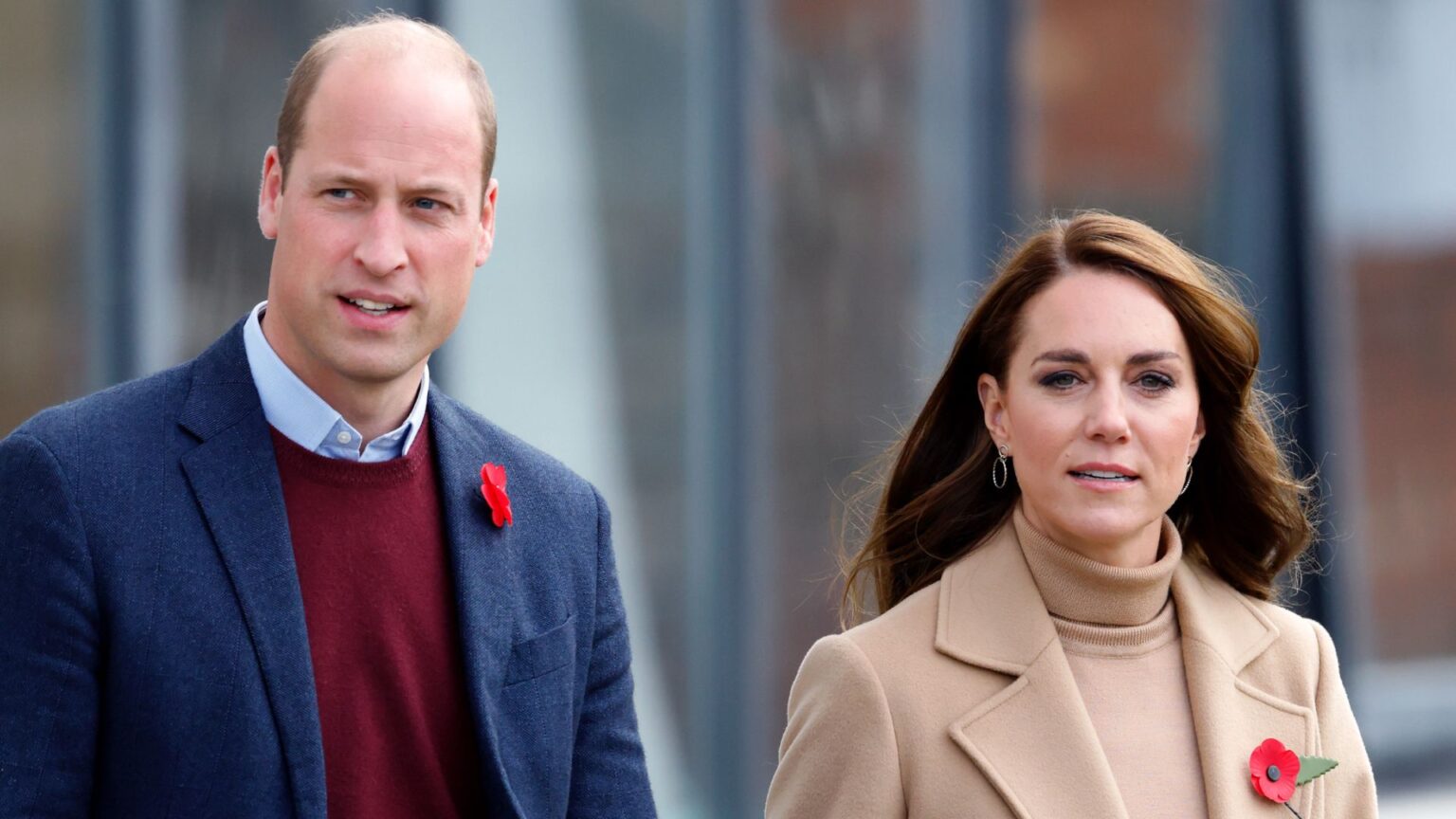 Princess Kate’s Police Officers Relocated Post-Investigation Prince William wears a red sweater and a navy coat and Princess Kate wears a beige coat with a matching turtleneck sweater