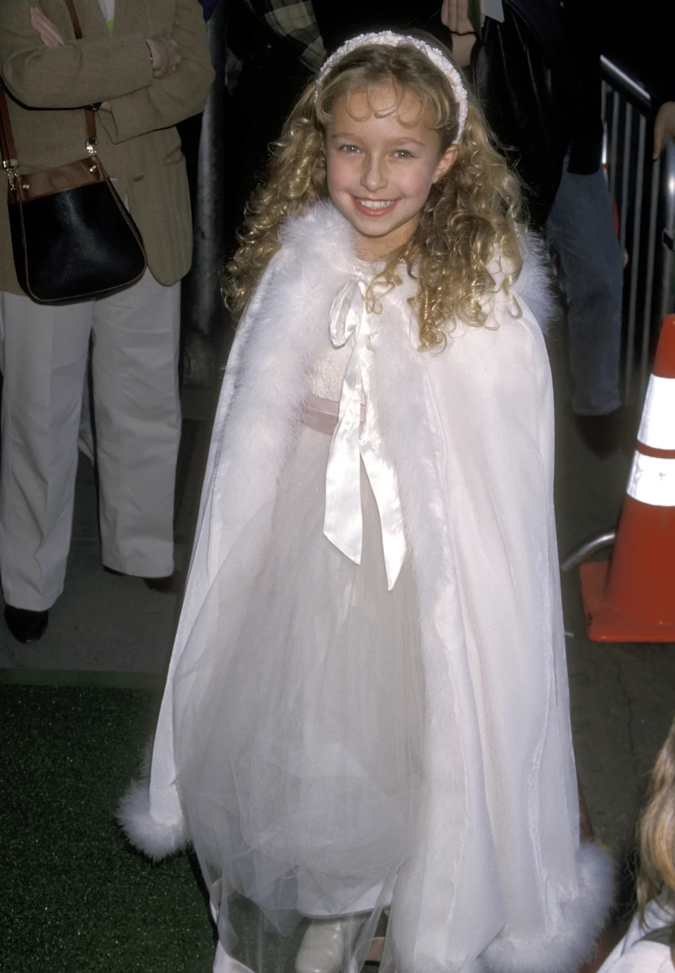 A little girl in all white on the red carpet
