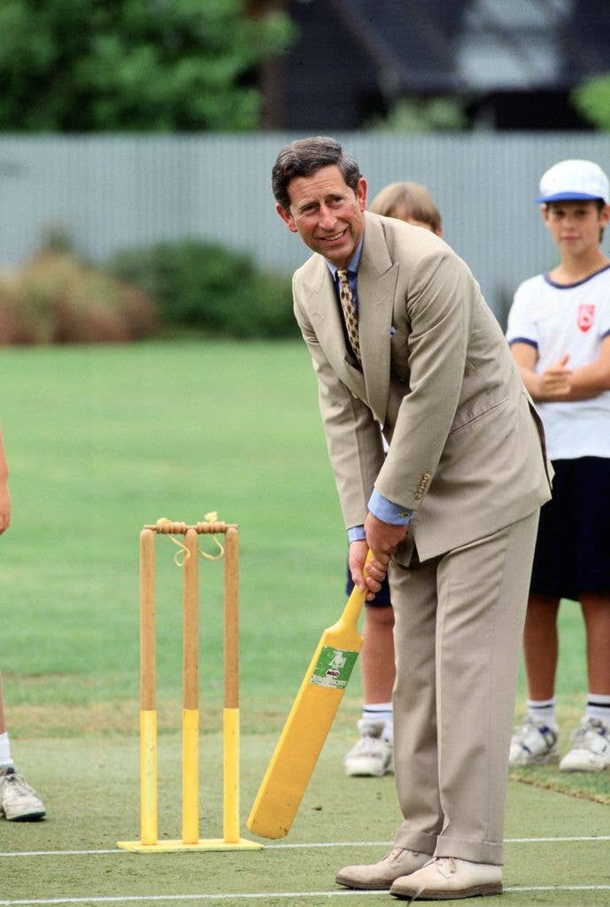 Charles, Prince of Wales tries his hand at cricket during a visit to Fendalton Primary School, Christchurch, New Zealand