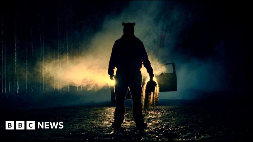 Essex filmmakers making slasher movie on a budget A silhouette of a figure in front of car headlights, at night. He is holding something ominous in his hand.