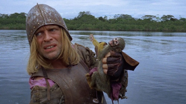Don Lope de Aguirre emerging from the Amazon holding a monkey in 