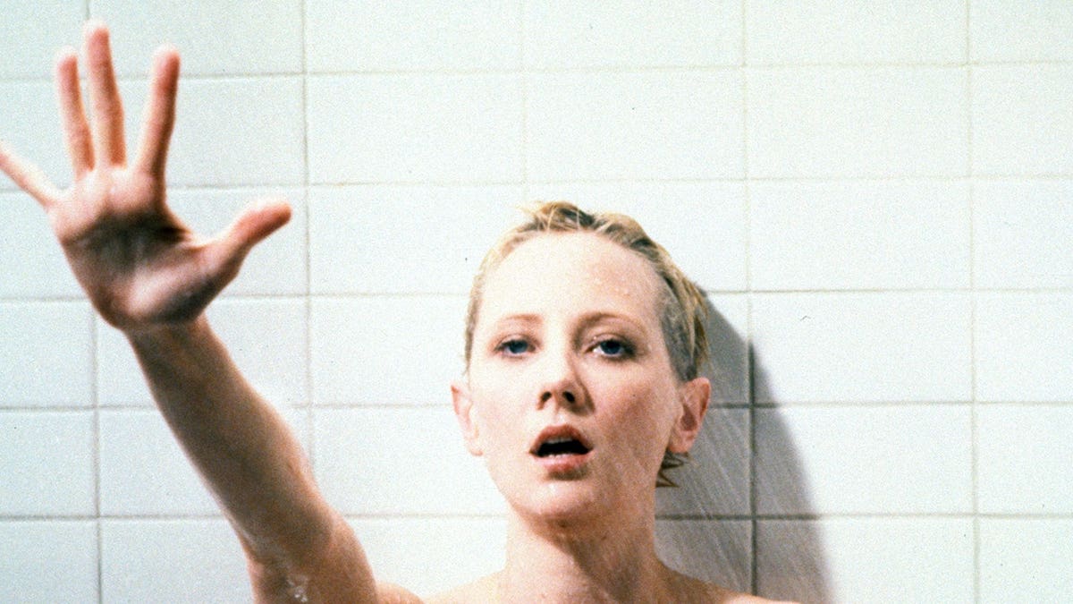 Anne Heche standing in a shower in a scene from the film Psycho