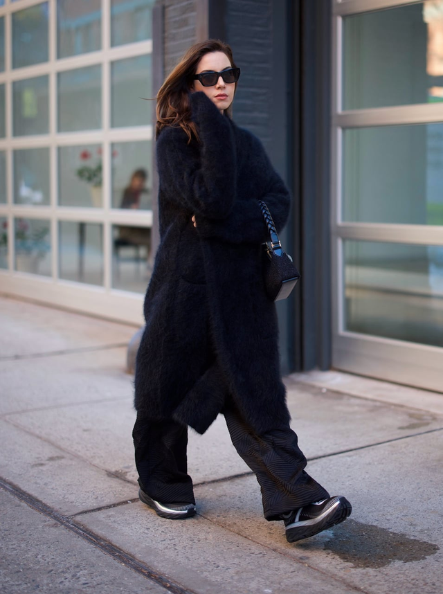 person walking on a sidewalk in urban setting