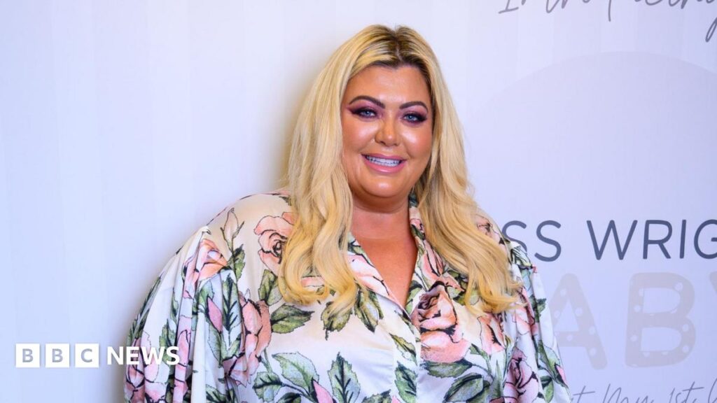 Department for Education receive backlash over Gemma Collins videos A woman with blonde hair wearing a white blouse with pink roses smiling.