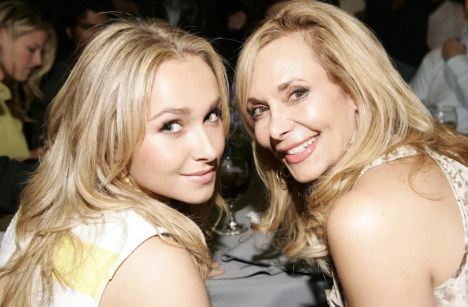 Two women looking over their shoulder at the camera.