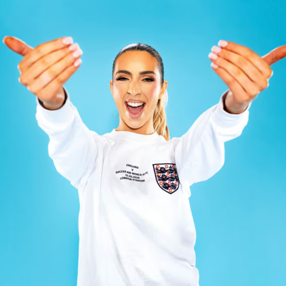 Soccer aid line up person gesturing with hands in front of a blue background