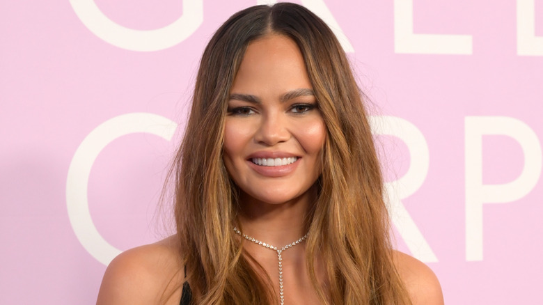 Chrissy Teigen with her hair down smiling