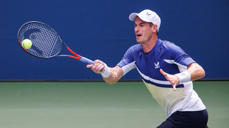 Famous tennis player Sir Andy Murray hitting the ball with a tennis raquet