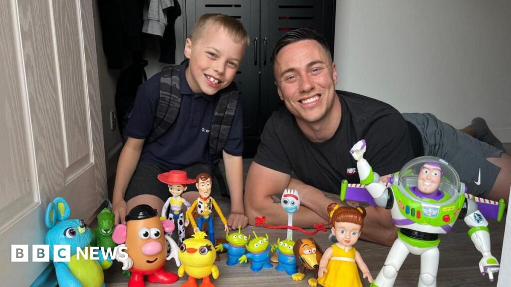 Toy Story superfan’s photo leads to premiere invite A child and his father lying at a doorstep with an array of toys from the Toy Story film franchise