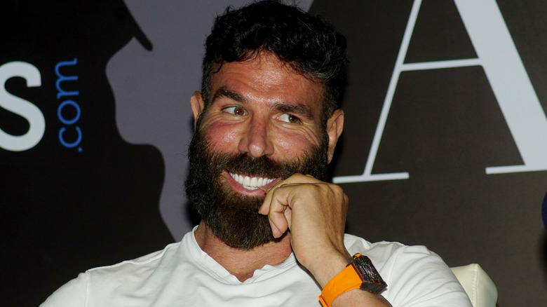 Dan Bilzerian smiles at an event.