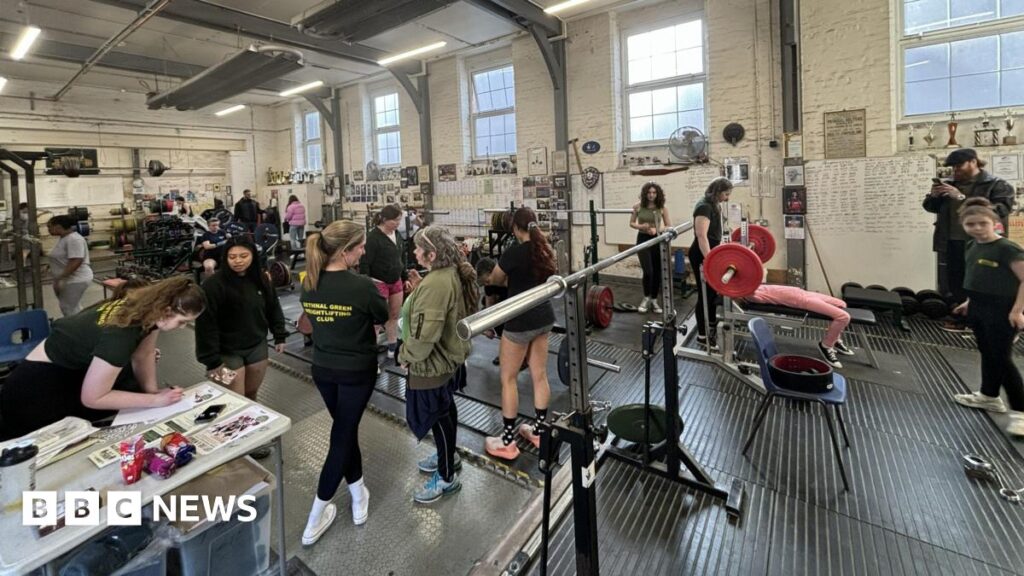 Bethnal Green Weightlifting Club asked to leave historic home Inside of weightlifting gym: shows weights, people using it and black floor. A table is on the left