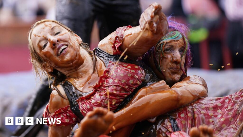 World Gravy Wrestling Championships move to Bacup Cricket Club Two women taking part in the World Gravy Wrestling Championships at the Rose 'N' Bowl, in Rossendale, Lancashire. The woman on the left has blond hair in plaits and wears a red spotted costume covered in gravy while a woman underneath her has her arms locked around her waist.