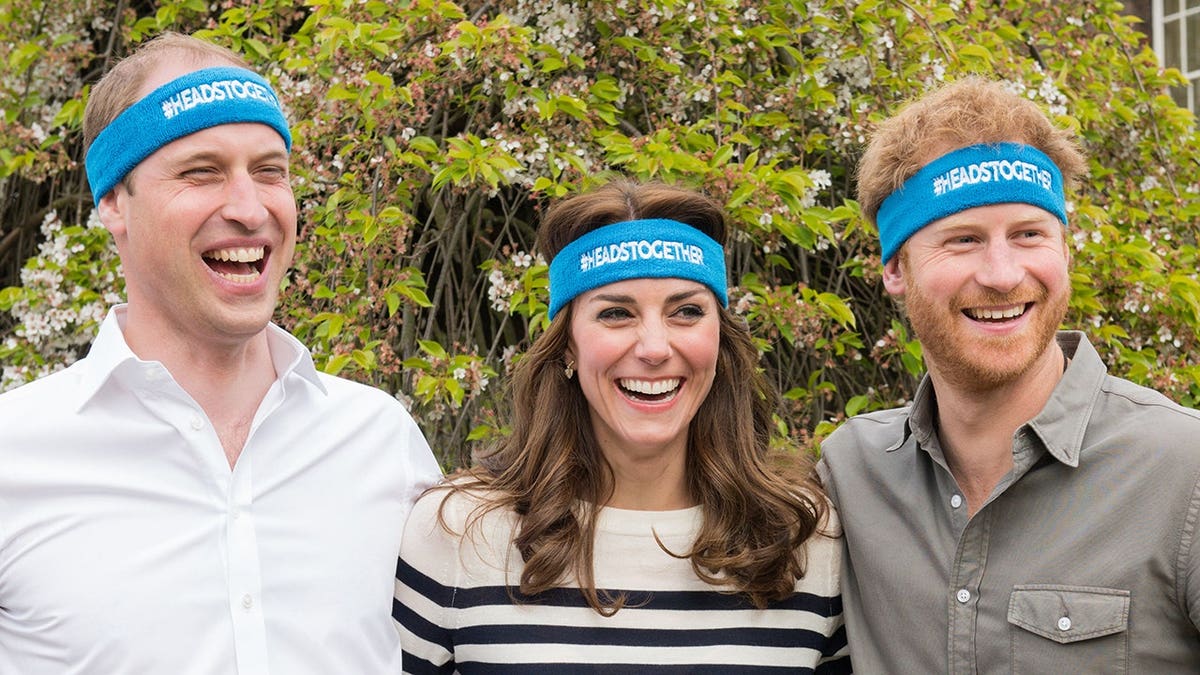 The Duke and Duchess of Cambridge and Prince Harry standing together at Kensington Palace
