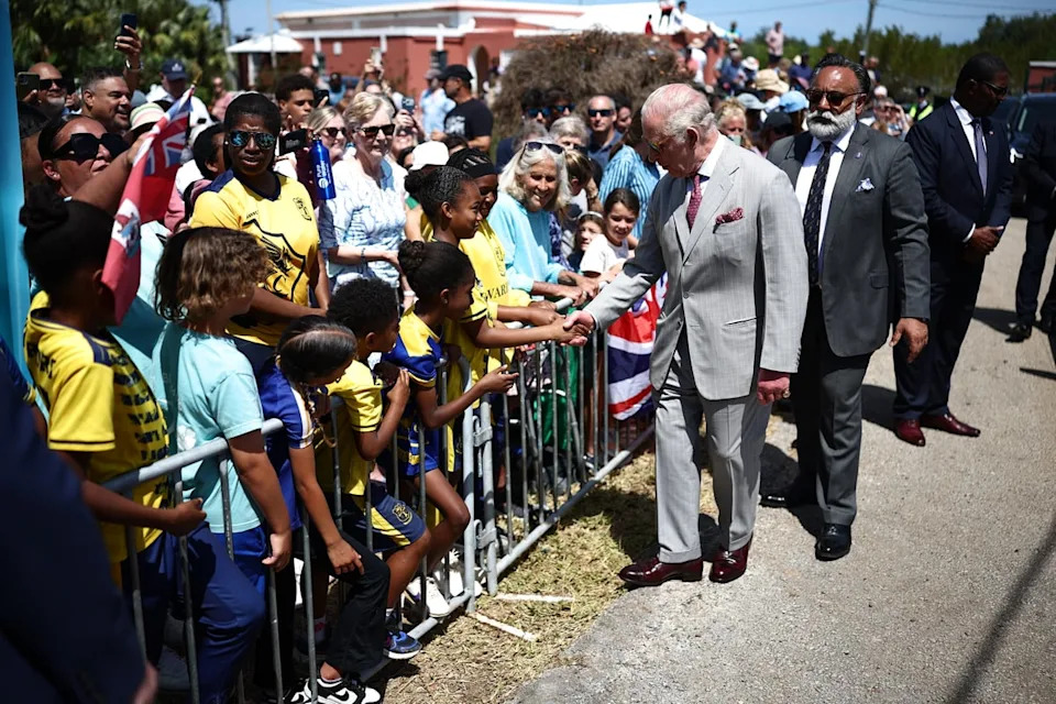King Charles III pictured with his bodyguard while meeting well-wishers during a visit to Great Bay Coast Guard Station (PA)